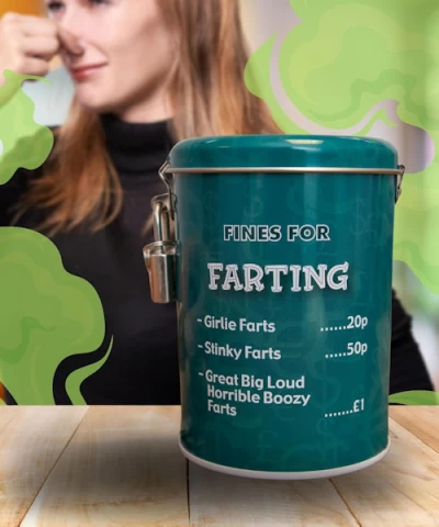 Brown leather key ring with brass metal loops and rivets on wood table.