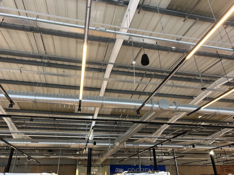 Silver pipework for heating and ventilation in retail store