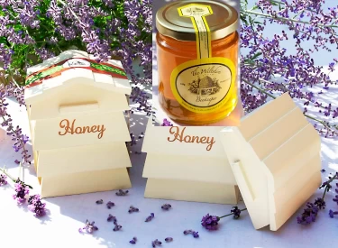 Photo of Wooden Beehive with a Jar of Clear Honey