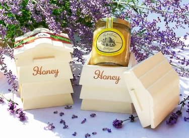 Photo of Wooden Beehive with a Jar of Set Honey