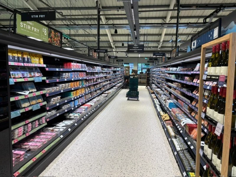 Aisle containing chilled cabinets with meat and fish