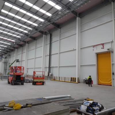 Inside of a warehouse with cherry picker.