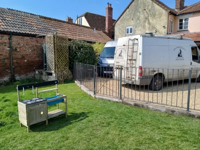 Image Captioned: Practical fencing and gate to keep the family pet from wandering. Our customer was very happy (I can't say the same for the dog)