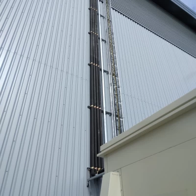 Photo showing the scale of this huge distribution centre and black refrigeration pipework running up the side