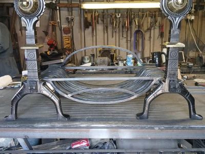 Image Captioned: Our customer asked us to restore his fire dogs and build a fire grate to go with them, he was more than happy.