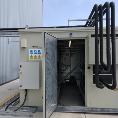 The outside of a refrigeration rack system with black pipework
