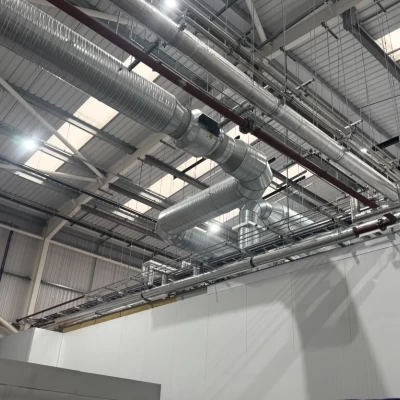 Large silver pipework showing the ventilation system at food manufacturing facility