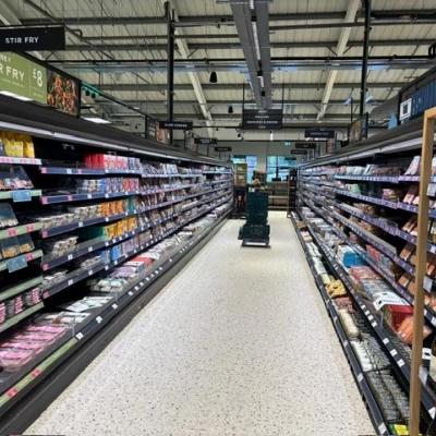 Aisle containing chilled cabinets with meat and fish